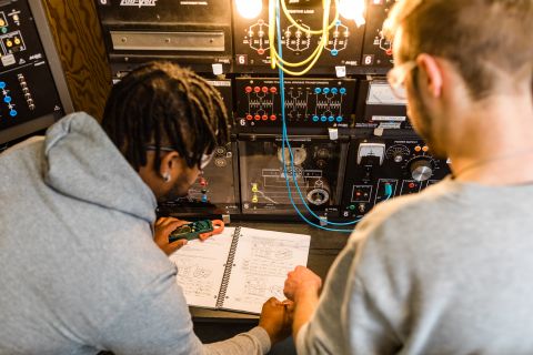 Two Electrical Pre-Apprenticeship students work on circuits