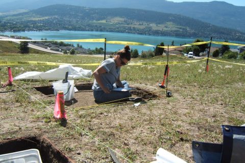 Anthropology student works on an excavation at the Vernon campus while overlooking Kal Lake