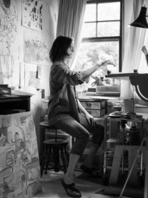 Amy Modahl paints by the light of a window in her home studio