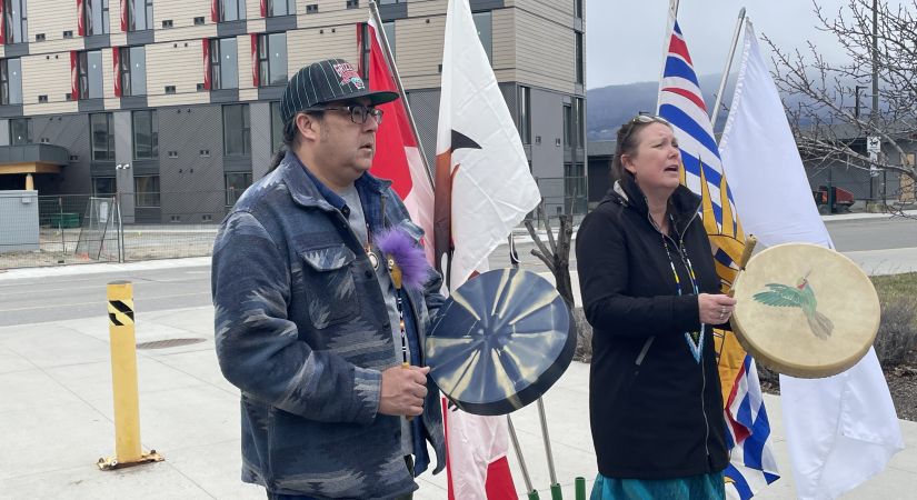 two people drumming in front of new Kelowna campus housing building