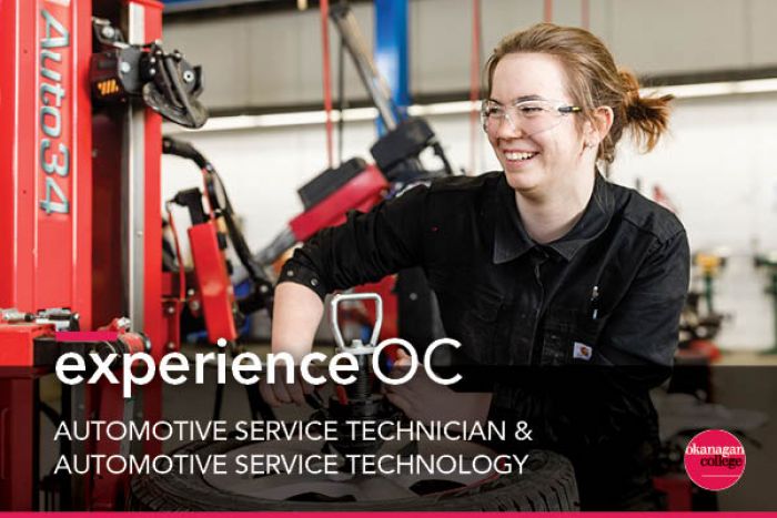 Student adjusts equipment in front of her in the automotive shop
