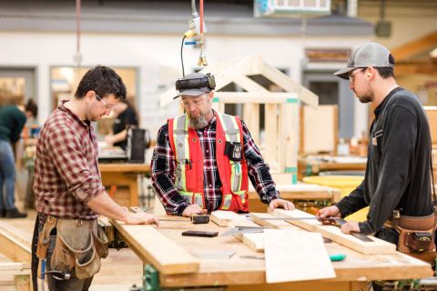 Students work in the Carpentry shop under the guidance of an instructor