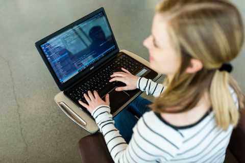 Student works on data science information on her laptop