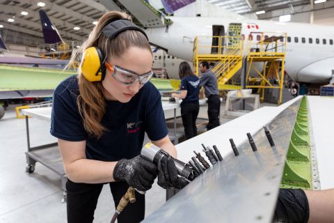 female aircraft maintenance engineer working on an aircraft