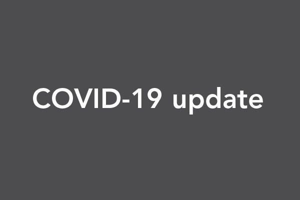 Text of "COVID-19 update" is overlain on a grey background