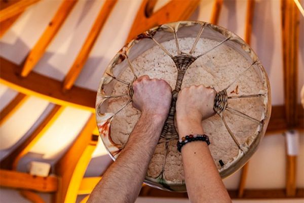 2 hands on an indigenous hand drum
