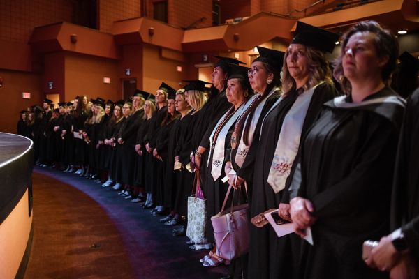 Graduates standing at the convocation ceremony in Vernon