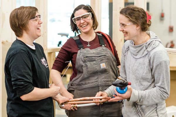 Three Women in Trades students working in the shop
