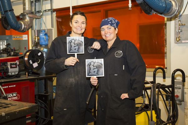Two Women of Steel participants show off what they made in the program.