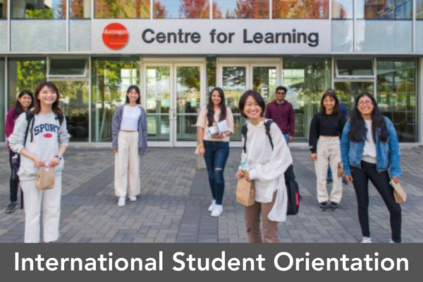 Several International students standing in front of the Centre for Learning building. 
