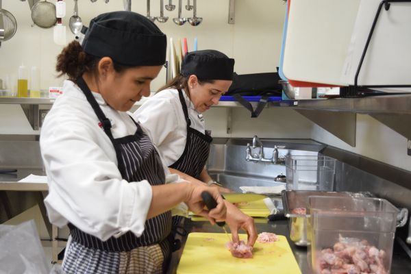 Student chefs prepare dinners for wildfire evacuees.