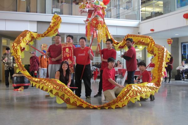 OC staff members pose with Dragon dancers at Lunar New Year celebration