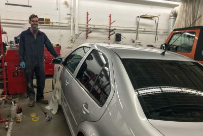 Collision Repair student working on a car in a shop