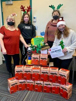 Salmon Arm employees pictured with apple juice boxes.