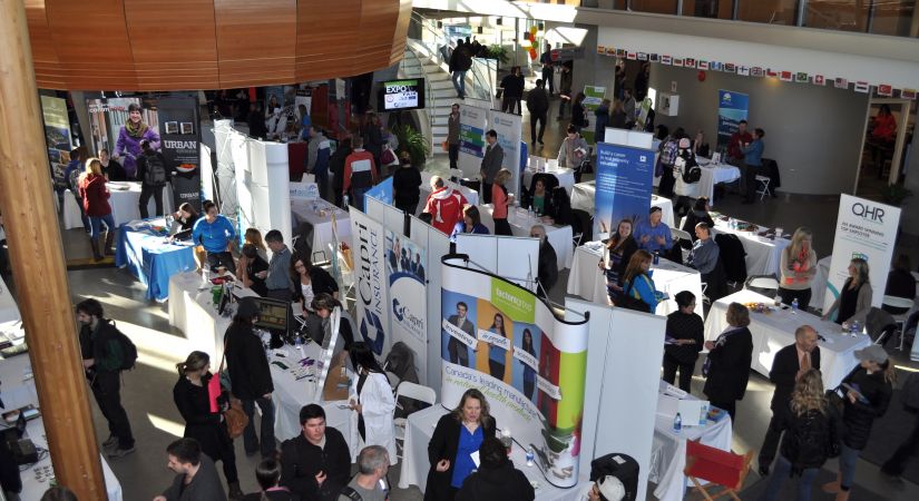 aerial view of booths set up in the Atrium with people interacting and mingling at Okanagan College's Annual Careers Expo and Employment Fair 