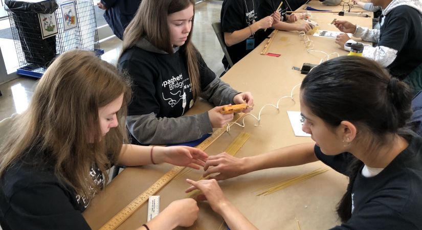 Students building bridges at the Spaghetti Bridge Building Contest