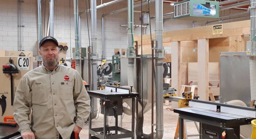 Carpentry instructor Trevor Fedderson stands in the woodworking shop