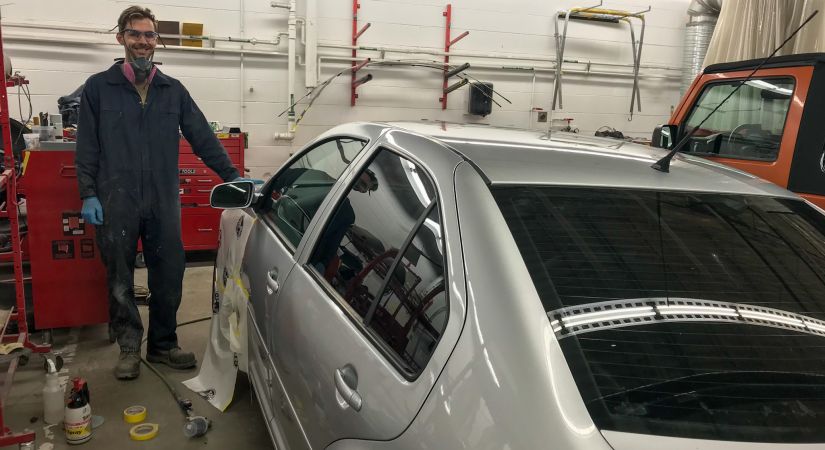 Collision Repair student working on a car in a shop