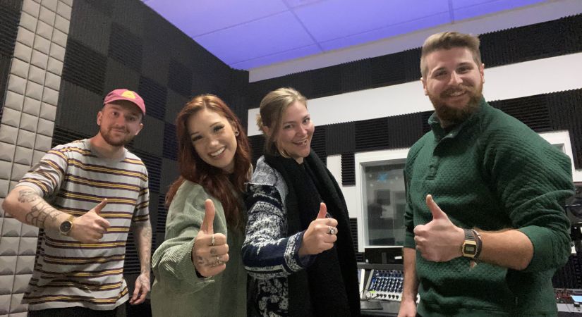 Jessica Bourelle and her musical production team give thumbs ups.